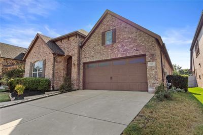 View of front facade with a garage and a front lawn | Image 2