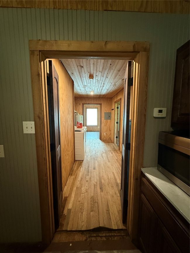 Corridor with light wood finished floors and wooden walls | Image 29