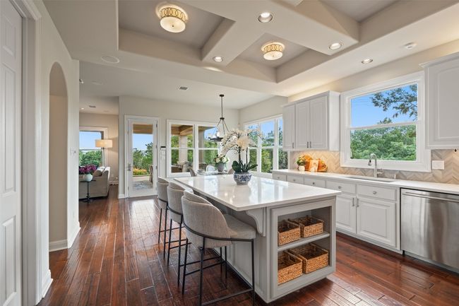 Kitchen with dishwasher, a sink, dark wood finished floors, white cabinetry, and recessed lighting | Image 17
