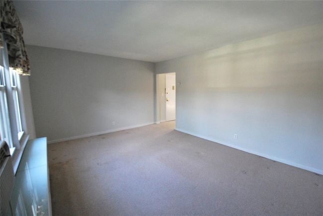 Living Room featuring light colored carpet and baseboards | Image 6