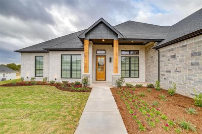 Front of home includes solid cedar beams, brick and stone. | Image 2