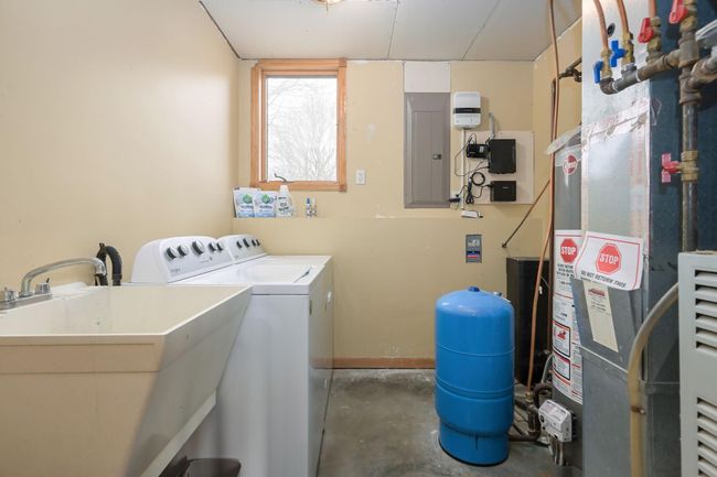 Laundry is located in the lower level and shares space with the mechanicals. | Image 48