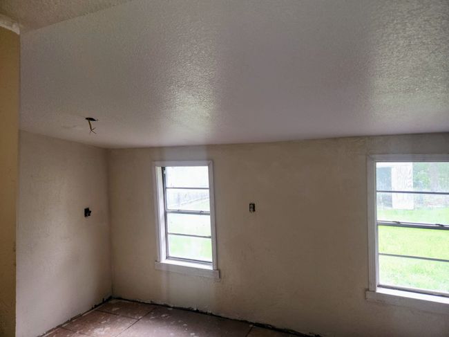 Empty room featuring a textured ceiling and a healthy amount of sunlight | Image 7