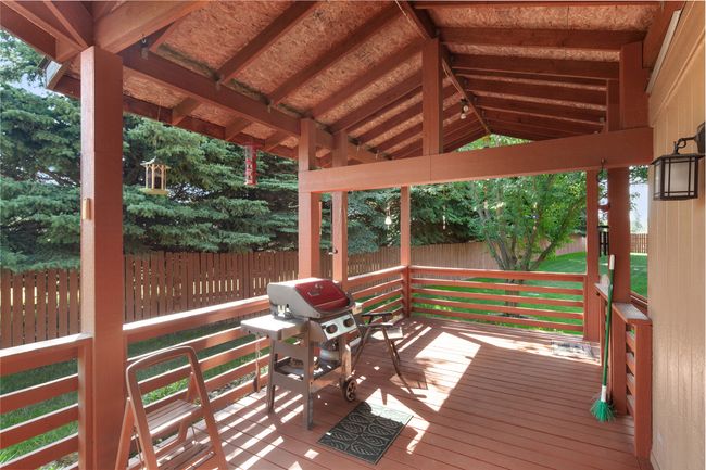 Deck featuring a fenced yard and grilling area | Image 42