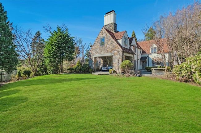 Property has both a sizable patio and green yard. | Image 33