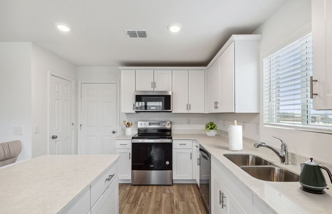 Bright kitchen with ample cabinet space *Photos of furnished model. Not actual home. Representative of floor plan. Some options and features may vary | Image 5