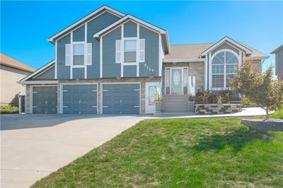 View of front facade featuring a garage and a front lawn | Image 2