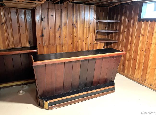 Semi-finished 'L' shaped basement with bar area. | Image 13