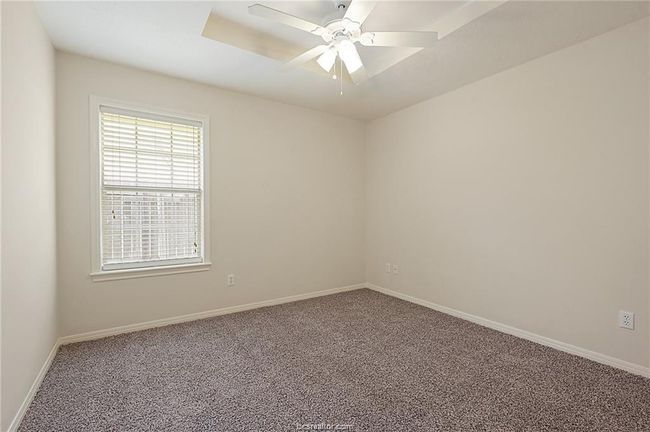 Spare room with carpet floors, baseboards, and a ceiling fan | Image 10