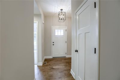 Doorway featuring an inviting chandelier and light hardwood / wood-style floors | Image 2