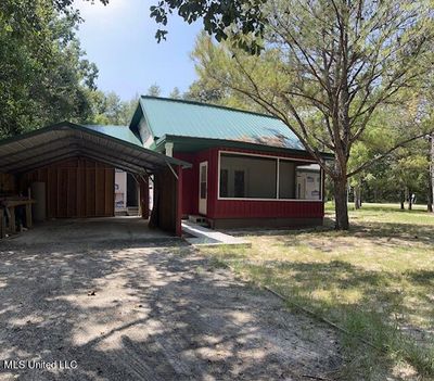 CARPORT AND NORTHSIDE OF HOME | Image 2