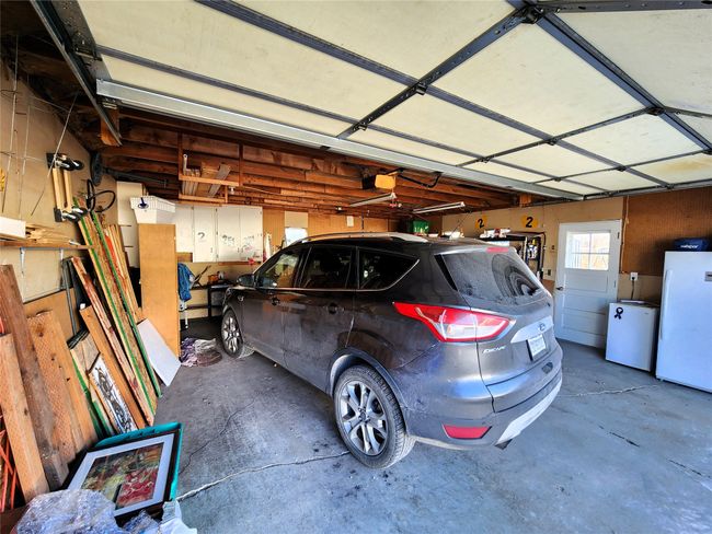 Garage with a garage door opener and freestanding refrigerator | Image 13