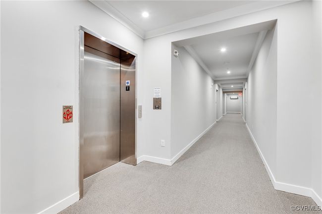 Corridor with elevator, carpet, crown molding, and recessed lighting | Image 37