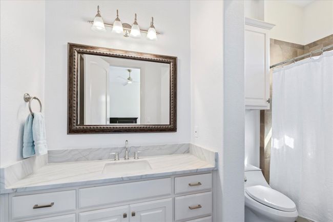 Bathroom with vanity, toilet, and a shower with curtain | Image 22