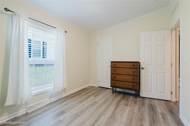Bedroom featuring light wood-type flooring and crown molding | Image 13