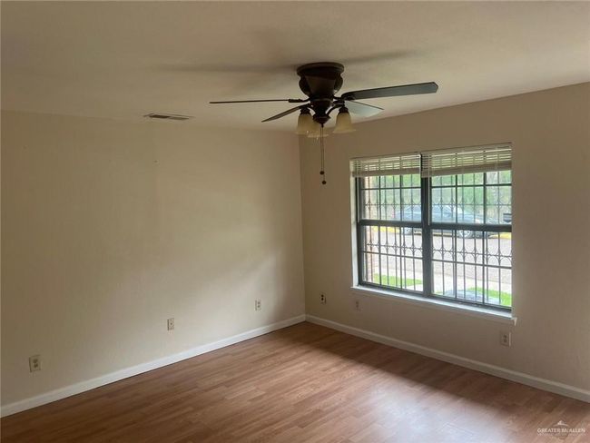 Unfurnished room featuring wood finished floors and ceiling fan | Image 5