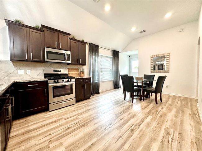 Another view of the spacious eat-in kitchen with abundant natural light and lots of upgrades. | Image 7