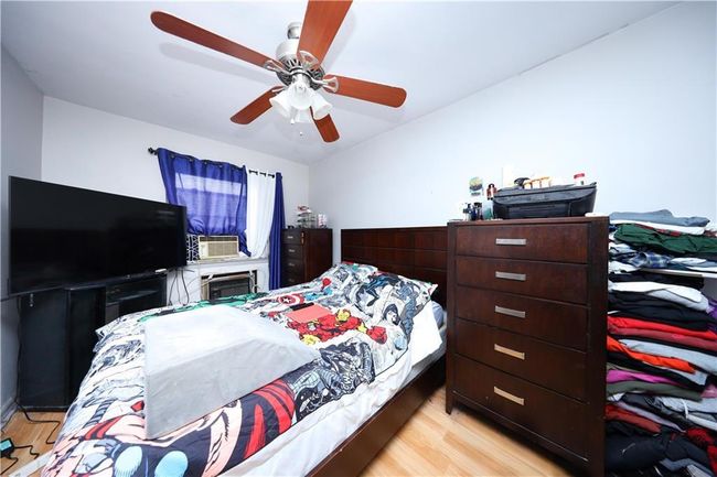 Bedroom featuring light wood finished floors and a ceiling fan | Image 18
