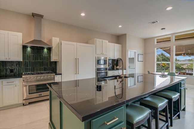 Custom cabinetry with 'hidden' fridge. | Image 11