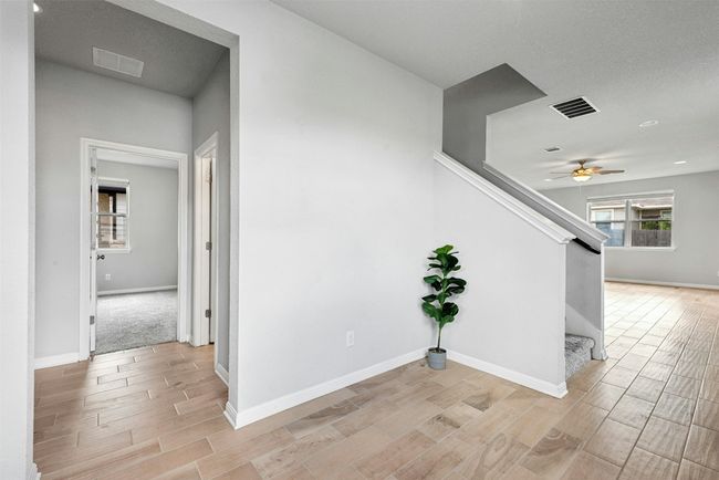 Hallway with wood finish floors and stairs | Image 5