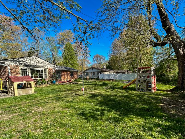Spacious backyard, partially fenced, mature trees | Image 26