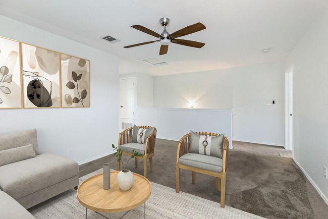 Living area featuring carpet, a ceiling fan, baseboards, and attic access | Image 7