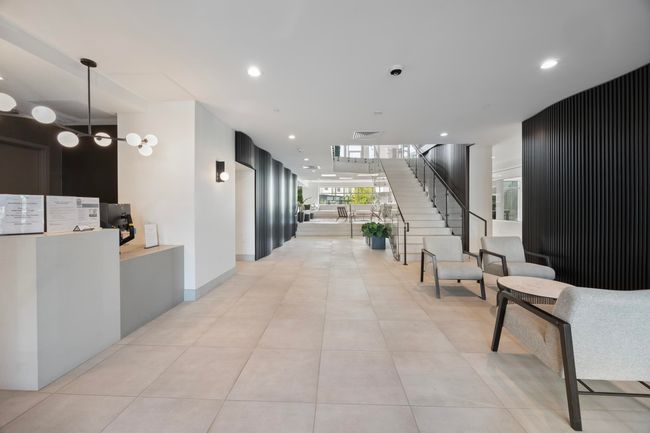 Corridor with light tile patterned floors, recessed lighting, visible vents, and stairway | Image 22