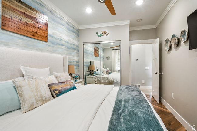 Bedroom featuring crown molding, wood finished floors, recessed lighting, a closet, and a ceiling fan | Image 57