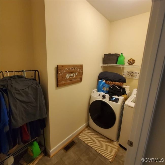 Laundry area featuring washing machine and clothes dryer, tile patterned flooring, visible vents, baseboards, and laundry area | Image 28