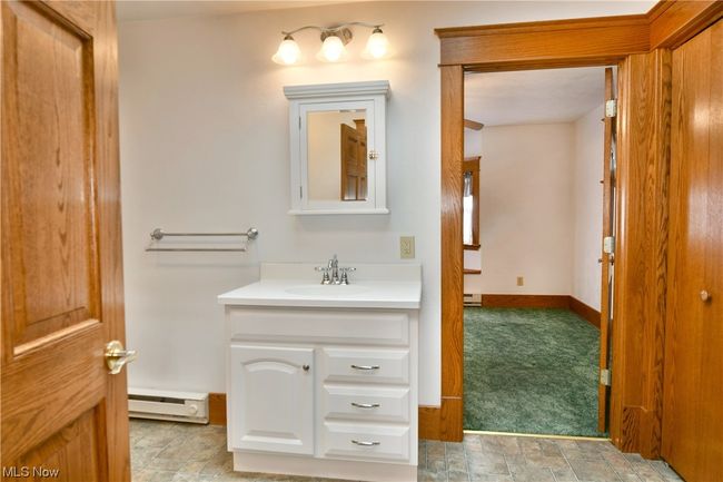 Bathroom with tile flooring, baseboard heating, and vanity | Image 17