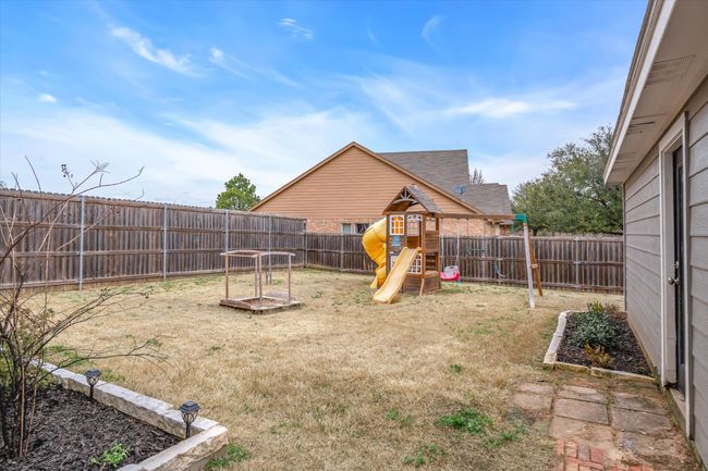 View of yard featuring a fenced backyard and a playground | Image 30