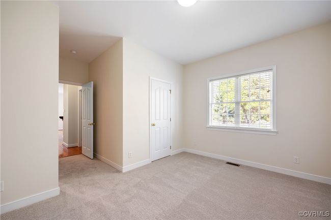 The oh - so desirable main level Bedroom {BR #5}, is actually large enough to be a bedroom. Isn't that a clever use and purpose? There is a closet plus full bath to round out the convenience. | Image 21