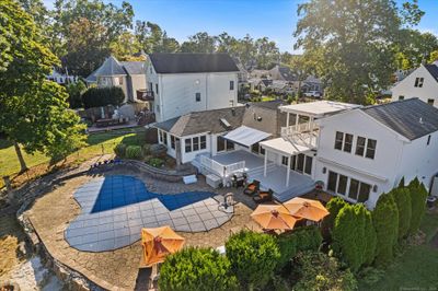 Back of this house shows the inground pool with spacious patio and outdoor entertaining features. | Image 2