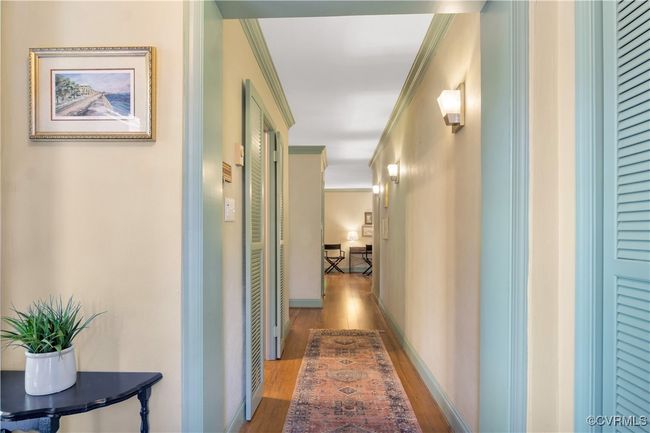 Hallway featuring crown molding and wood finished floors | Image 5