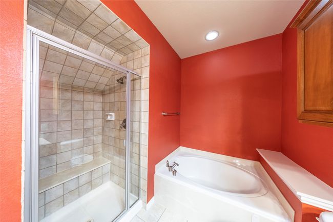 Full bath with a stall shower, a bath, and tile patterned floors | Image 21