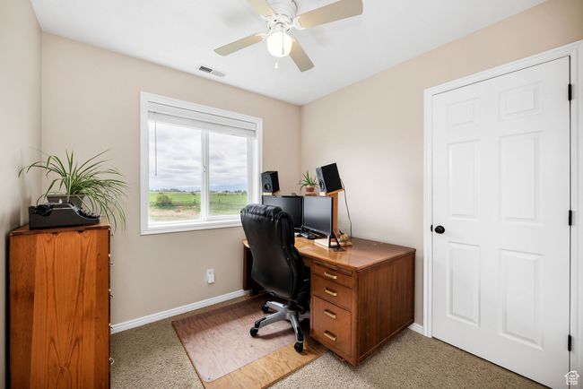 Office space/Bedroom with baseboards, a ceiling fan, and light colored carpet | Image 14
