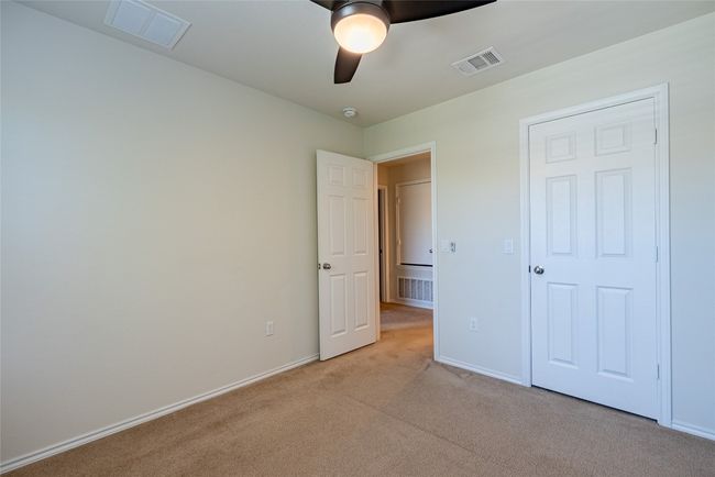 Unfurnished bedroom with light carpet and ceiling fan | Image 21