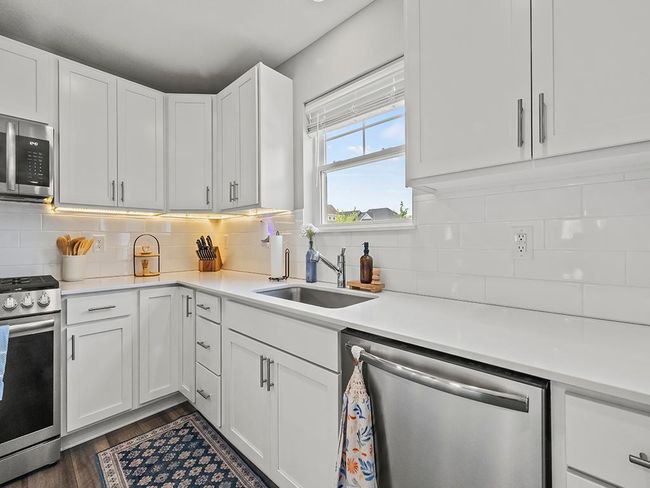 Kitchen sink window and under cabinet lighting make the space extra bright! | Image 7