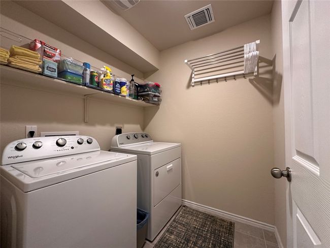 Laundry room featuring washer and dryer, baseboards, and tile patterned flooring | Image 18