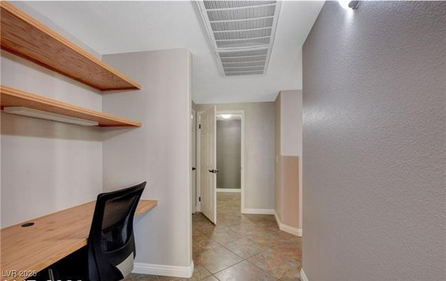 Unfurnished office with light tile patterned floors, visible vents, and baseboards | Image 11