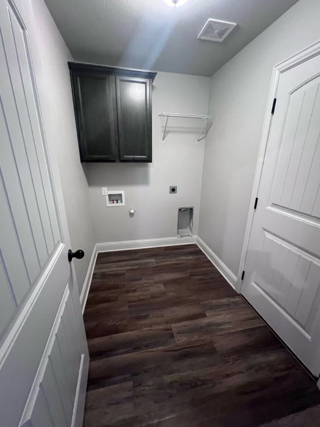 Laundry room featuring dark wood-style floors, hookup for an electric dryer, baseboards, and hookup for a gas dryer | Image 31