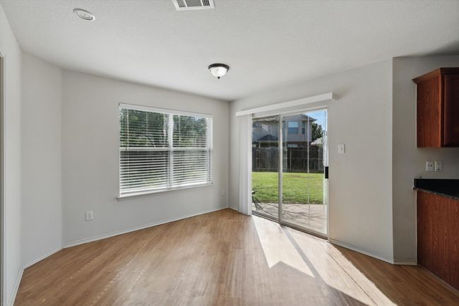 Unfurnished dining area with light wood-type flooring, plenty of natural light, and baseboards | Image 5