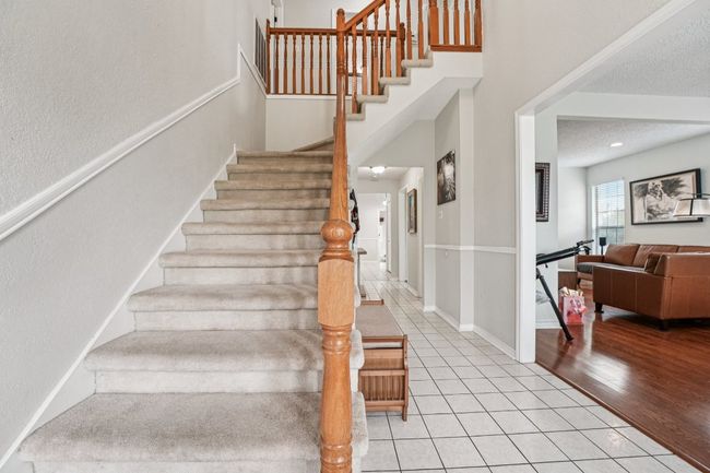 Stairs with tile patterned flooring and baseboards | Image 21