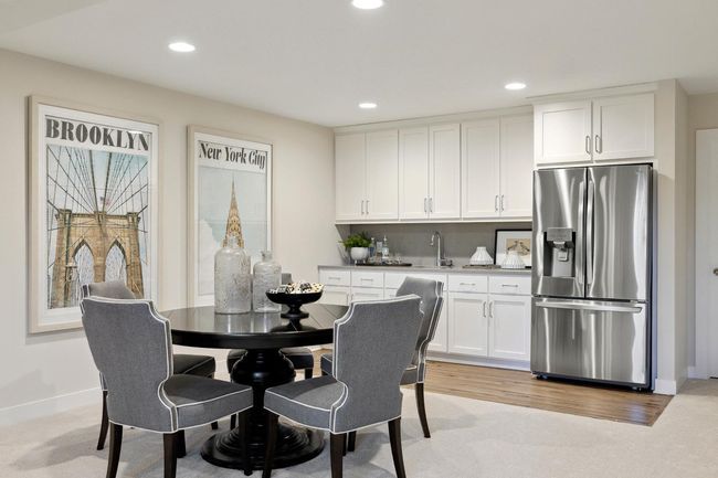Finished Lower Level with Wet Bar and full-size fridge. Photos may not depict actual home plan configuration. Features/materials/finishes shown contain options that are not included in price. | Image 19