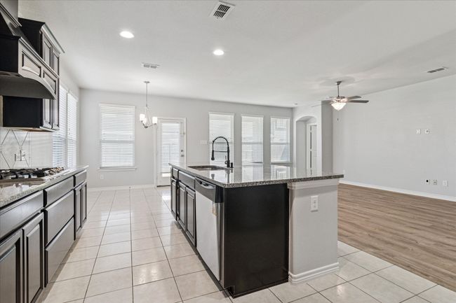 Kitchen with a sink, visible vents, appliances with stainless steel finishes, and light tile patterned flooring | Image 14