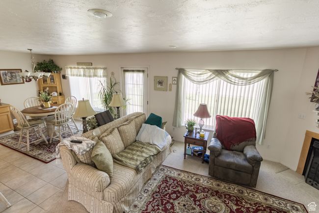Living area with a chandelier | Image 25