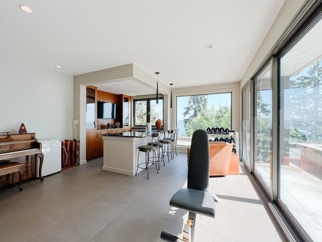 Dining room featuring healthy amount of natural light, light tile patterned floors, and recessed lighting | Image 25