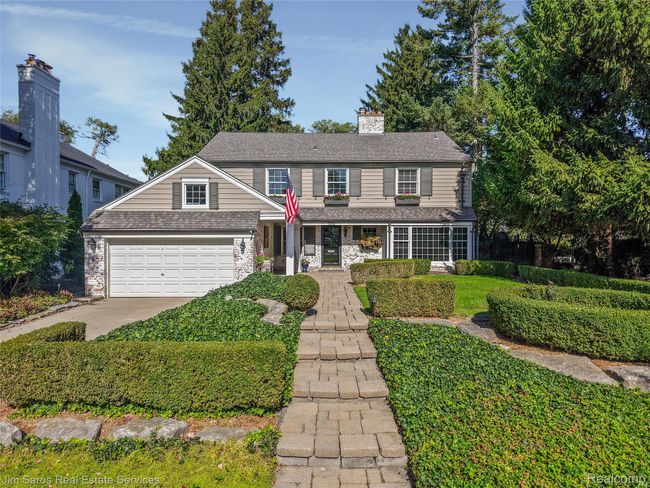 Traditional-style home with a porch, a chimney, stone siding, and roof with shingles | Image 36