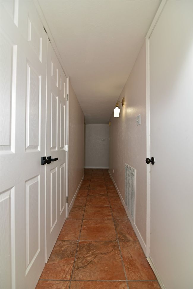 Corridor featuring Laundry Area and Garage entrance | Image 13