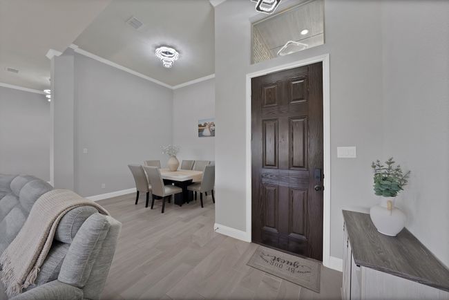 Foyer with crown molding, baseboards, and light wood-style flooring | Image 15